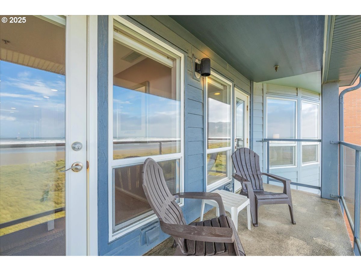361 South Promenade, Unit 502 Seaside, OR 97138 - Photo 41 of 46 a view of a hallway with wooden floor and glass door