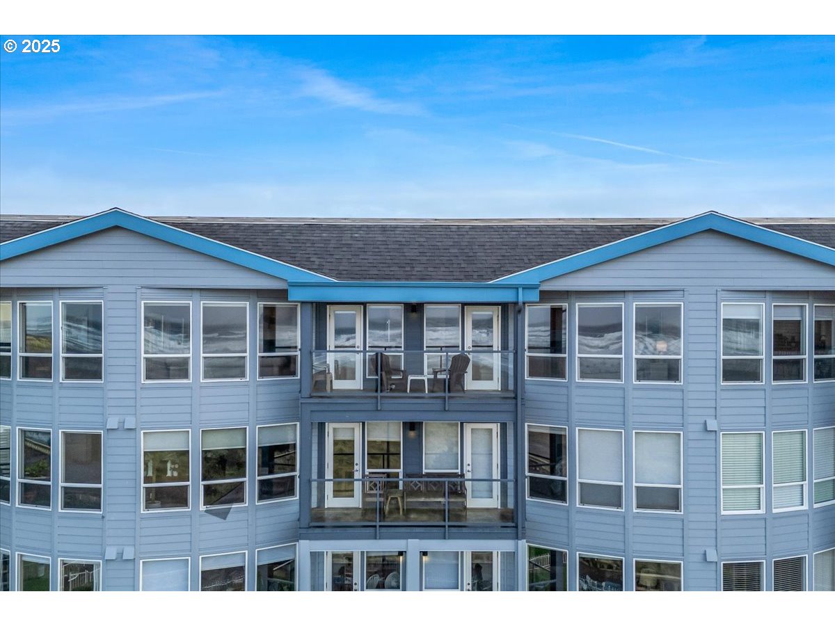 361 South Promenade, Unit 502 Seaside, OR 97138 - Photo 6 of 46 a view of a brick building next to a yard