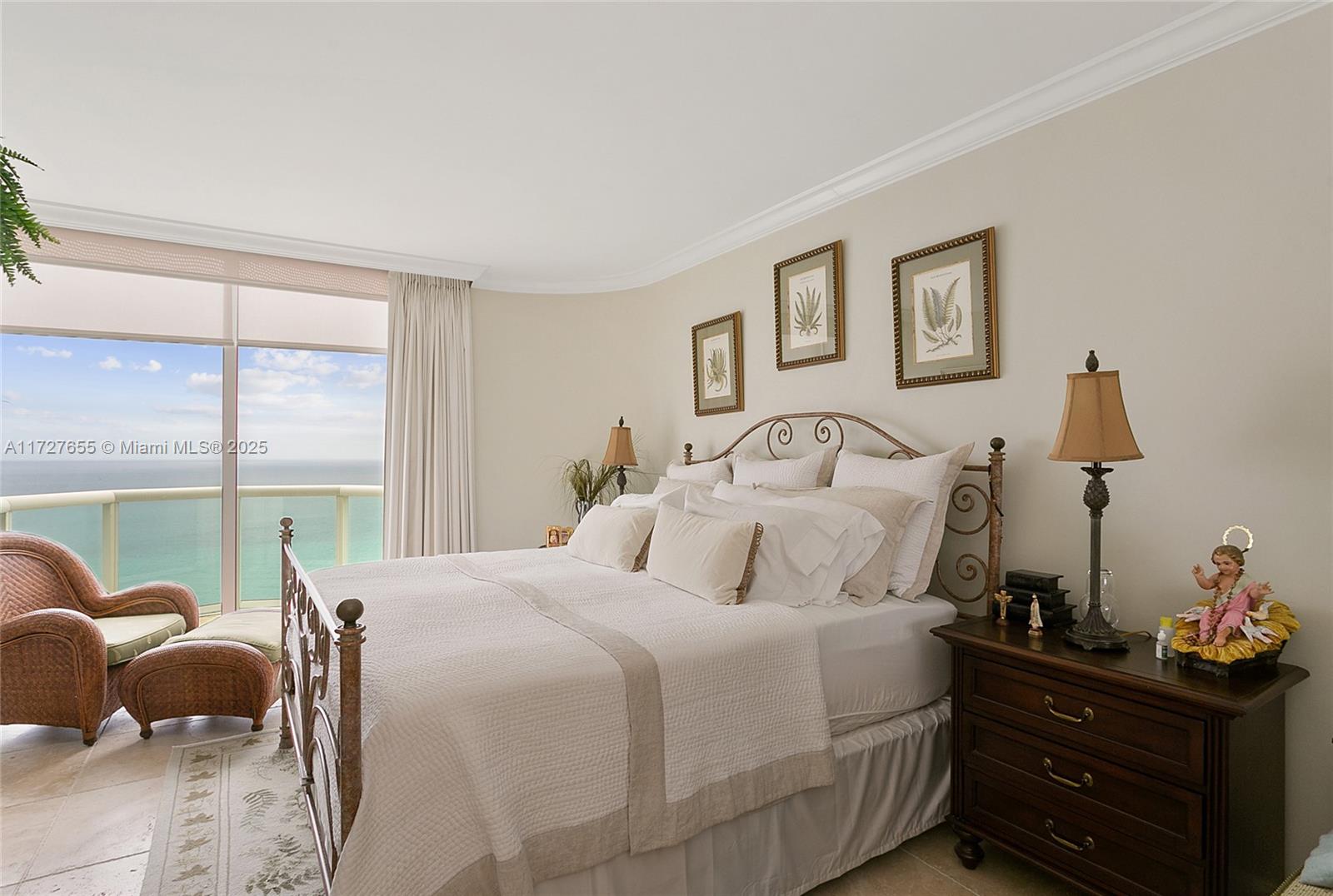 6365 Collins Avenue, Unit 3401 Miami Beach, FL 33141 - Photo 13 of 20 a bedroom with a bed and large windows