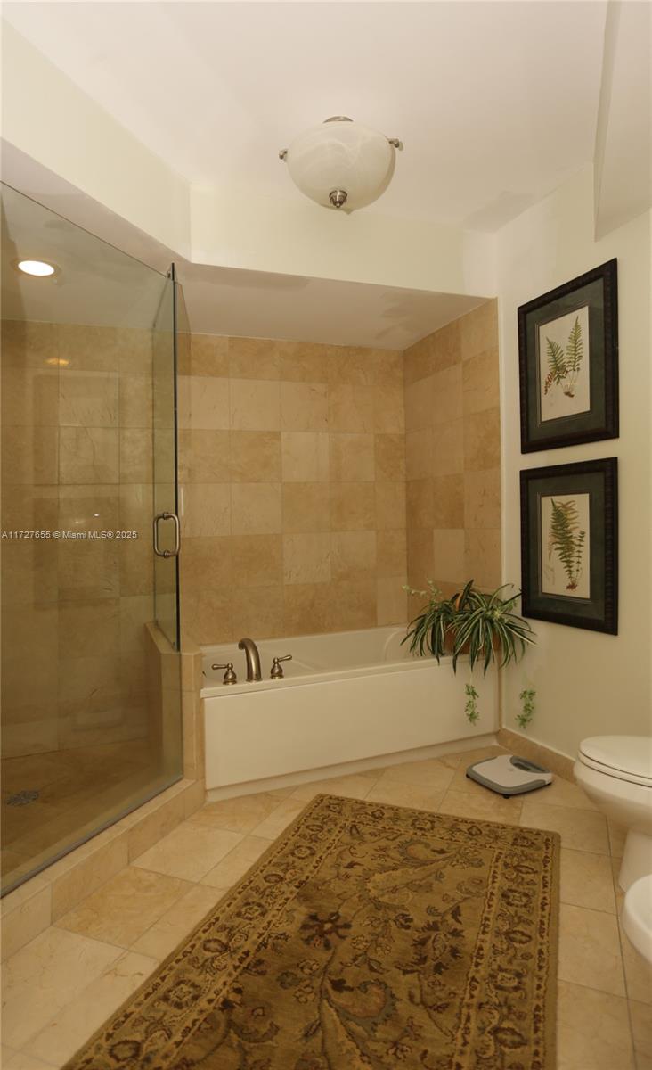 6365 Collins Avenue, Unit 3401 Miami Beach, FL 33141 - Photo 14 of 20 a bathroom with a shower