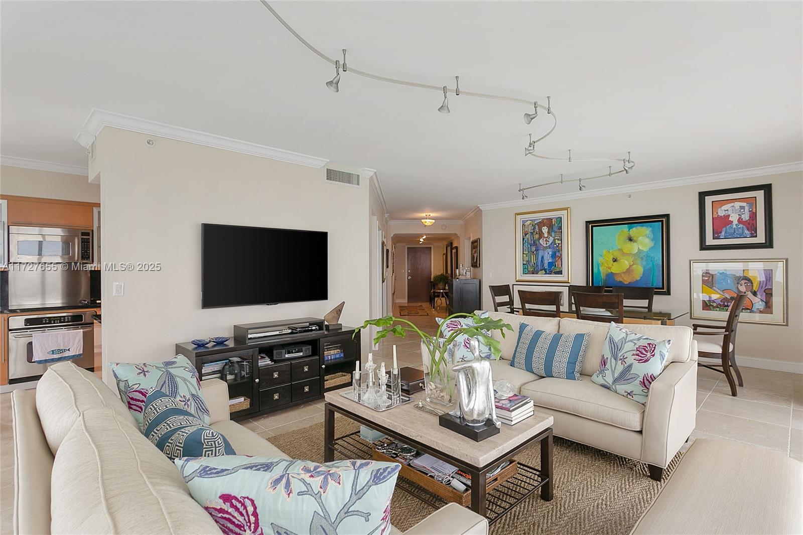 6365 Collins Avenue, Unit 3401 Miami Beach, FL 33141 - Photo 2 of 20 a living room with furniture and a flat screen tv