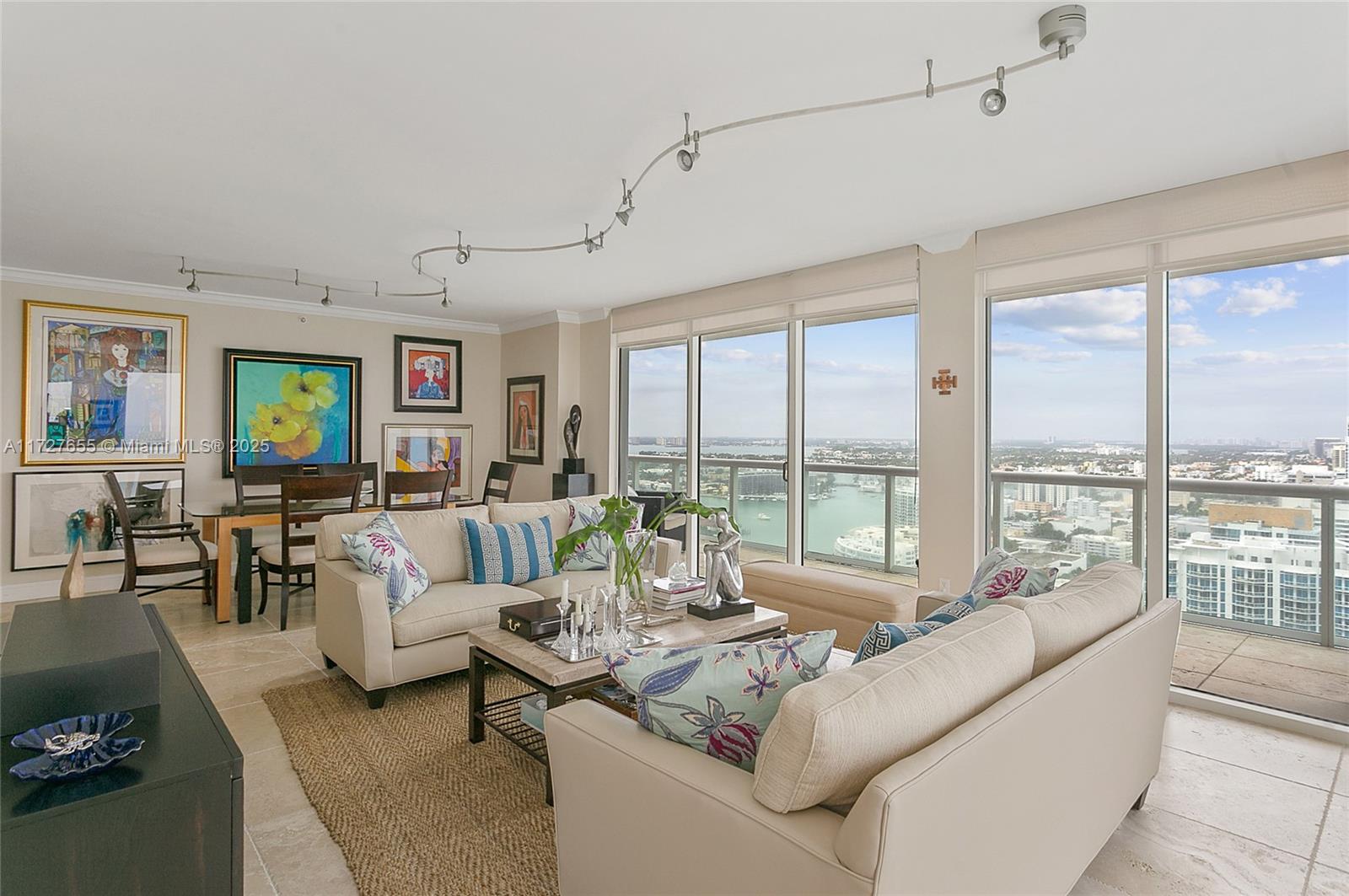 6365 Collins Avenue, Unit 3401 Miami Beach, FL 33141 - Photo 4 of 20 a living room with furniture and floor to ceiling windows