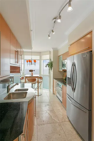 a kitchen with kitchen island a counter top space appliances and cabinets
