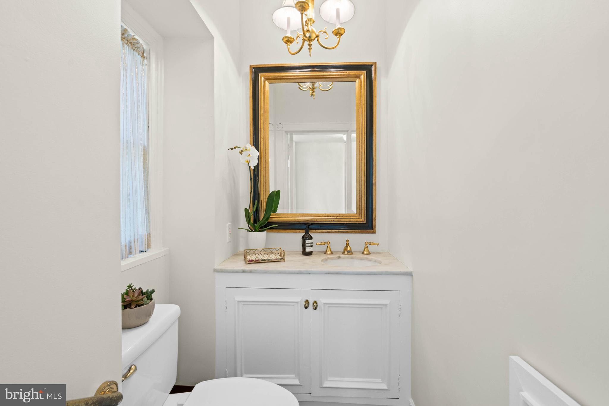 2325 Porter Street Northwest Washington, DC 20008 - Photo 16 of 50 a bathroom with a sink vanity and a mirror
