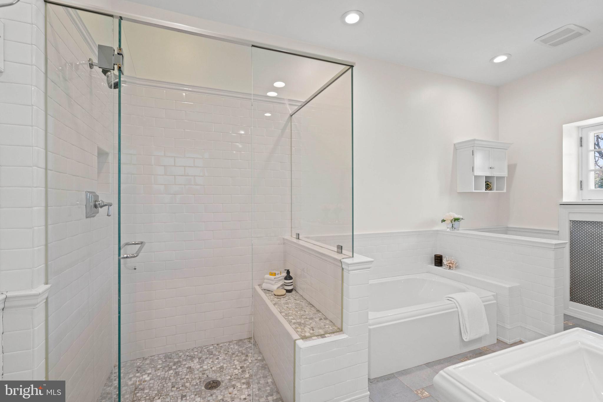 2325 Porter Street Northwest Washington, DC 20008 - Photo 22 of 50 a bathroom with a tub shower vanity and a sink