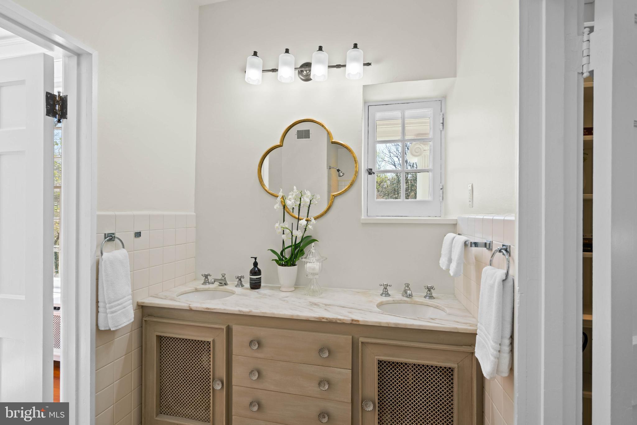 2325 Porter Street Northwest Washington, DC 20008 - Photo 27 of 50 a bathroom with a sink double vanity and a mirror