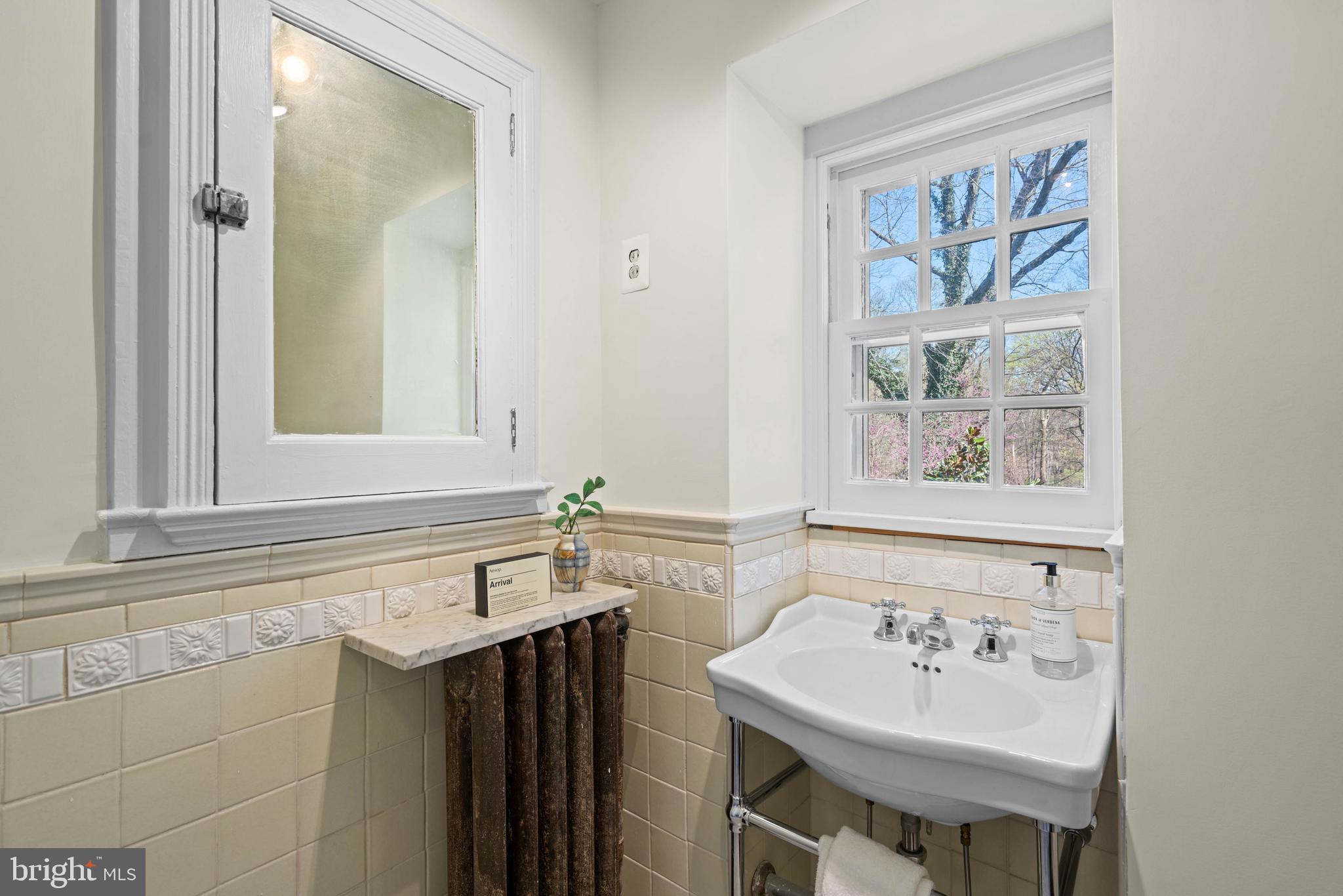 2325 Porter Street Northwest Washington, DC 20008 - Photo 29 of 50 a bathroom with a sink and a mirror