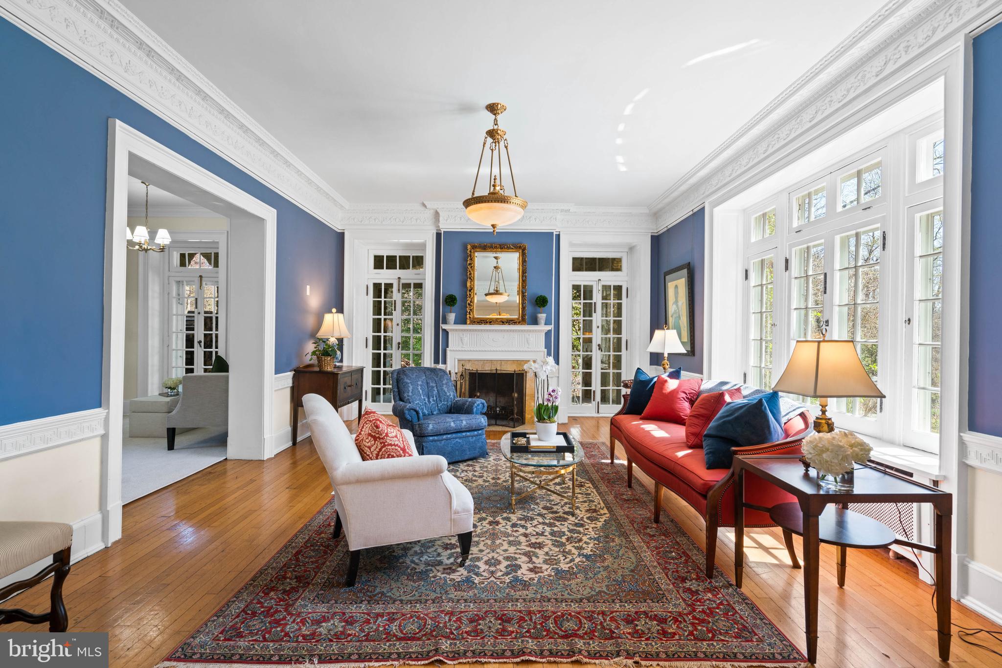 2325 Porter Street Northwest Washington, DC 20008 - Photo 6 of 50 a living room with furniture a fireplace and a chandelier