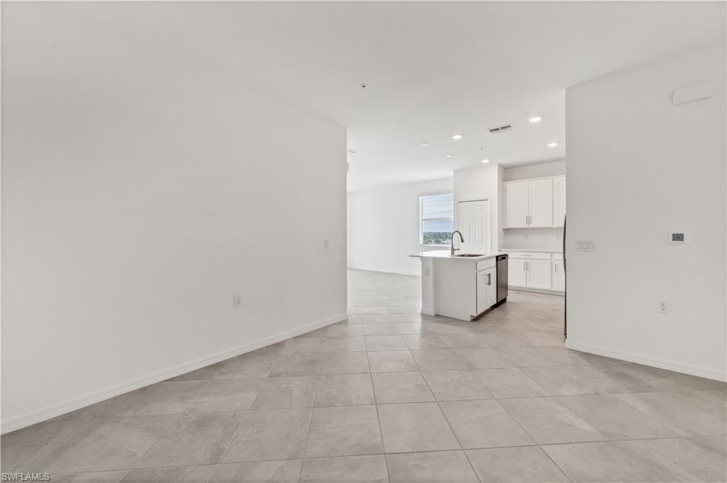 43997 Boardwalk Loop, Unit 1838 Punta Gorda, FL 33982 - Photo 22 of 45 a view of a kitchen with a sink and dishwasher a refrigerator with white cabinets
