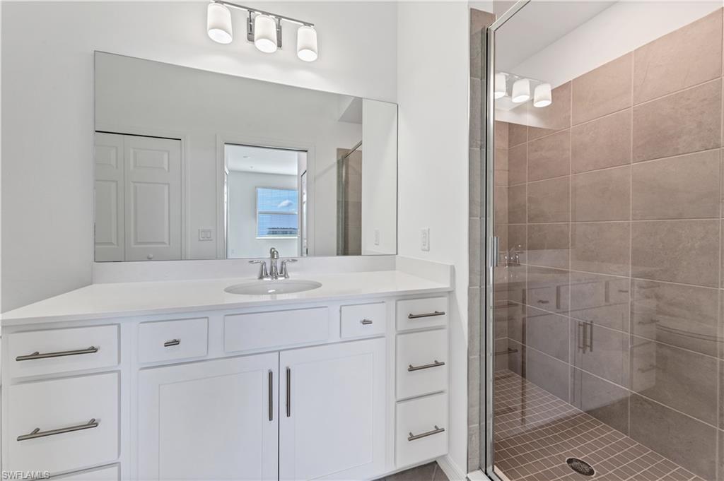 43997 Boardwalk Loop, Unit 1838 Punta Gorda, FL 33982 - Photo 29 of 45 a bathroom with a sink a vanity and a mirror