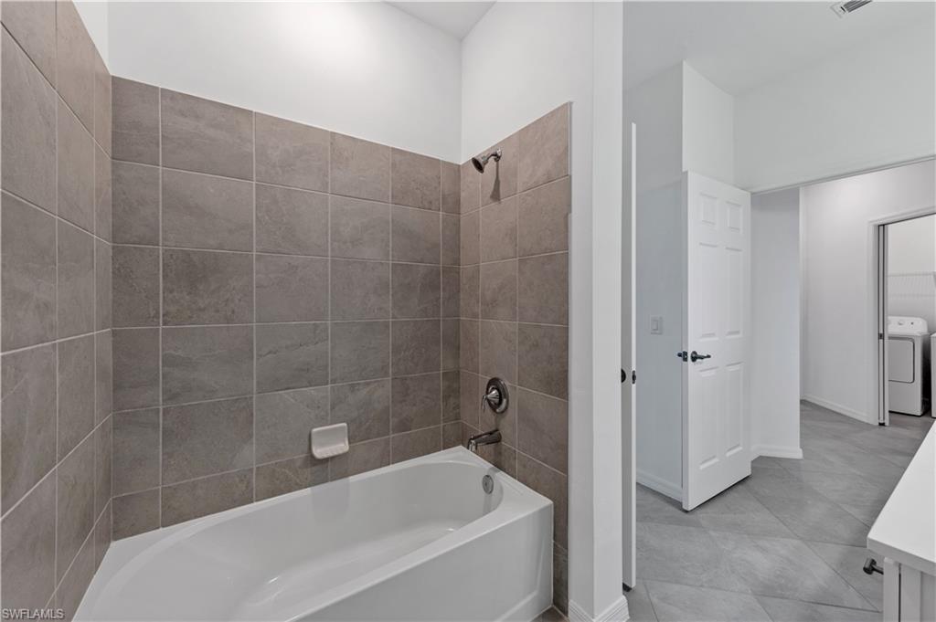 43997 Boardwalk Loop, Unit 1838 Punta Gorda, FL 33982 - Photo 34 of 45 a bathroom with a bathtub and a shower