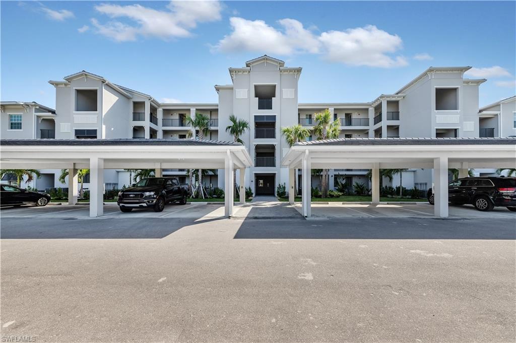 43997 Boardwalk Loop, Unit 1838 Punta Gorda, FL 33982 - Photo 8 of 45 a front view of residential building and car parked