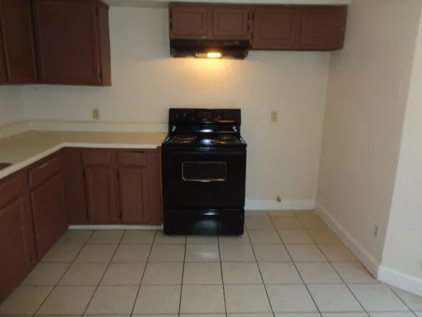 a kitchen with a cabinets and a stove top oven