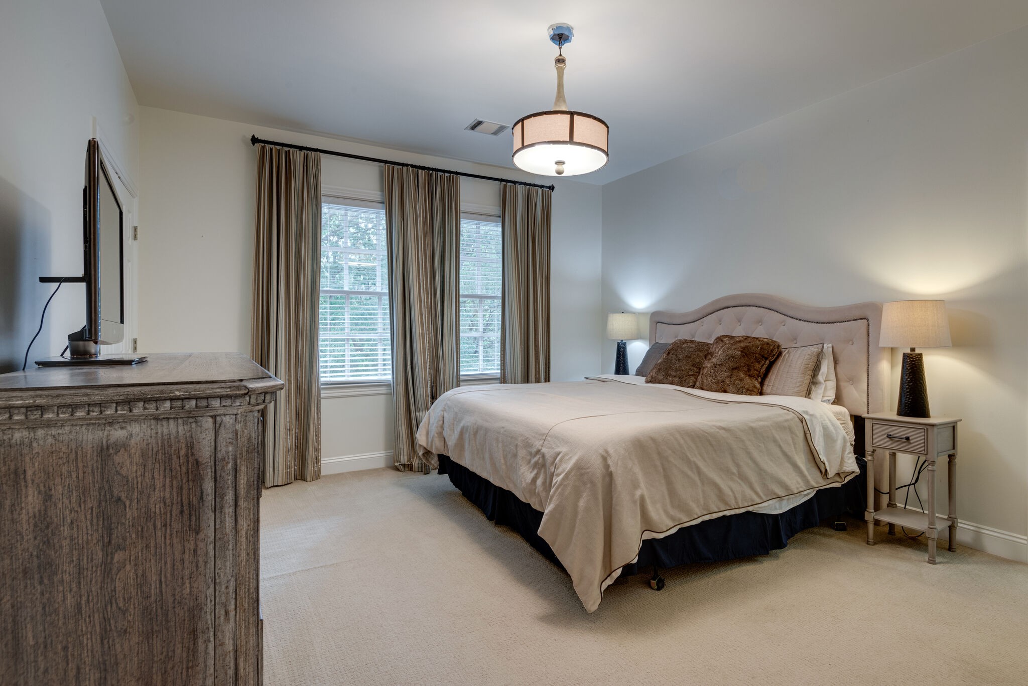 1432 Willowbrooke Circle Franklin, TN 37069 - Photo 31 of 41 a bedroom with a bed lamps and a large mirror