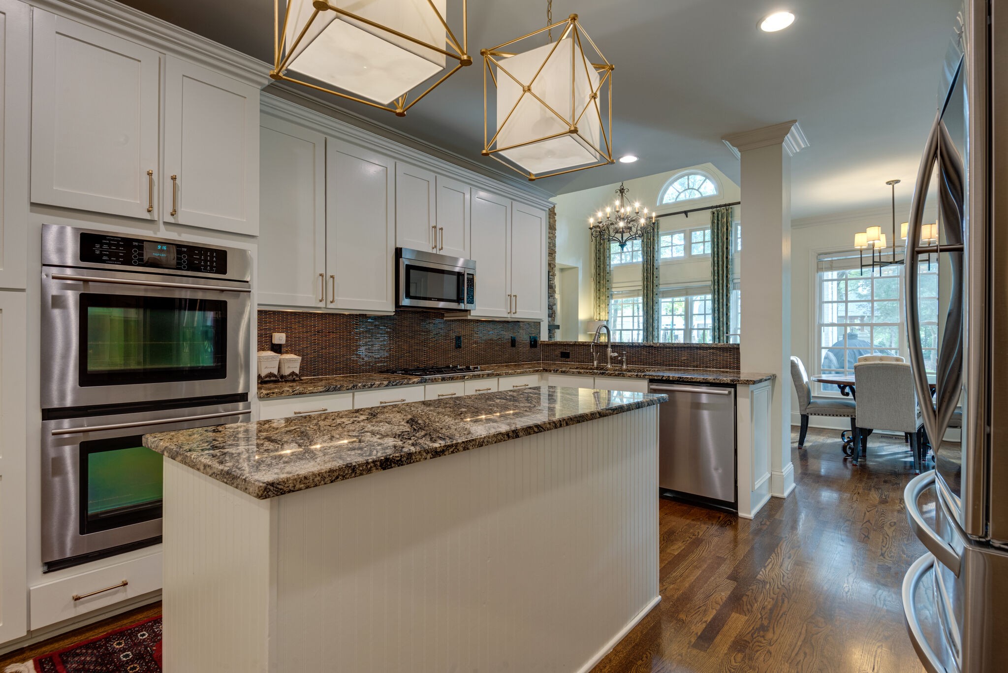 1432 Willowbrooke Circle Franklin, TN 37069 - Photo 8 of 41 a kitchen with kitchen island granite countertop a stove sink and microwave