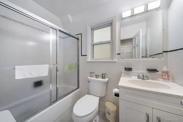 a white toilet sitting next to a bathroom sink