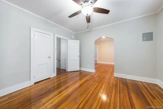 a view of empty room with wooden floor