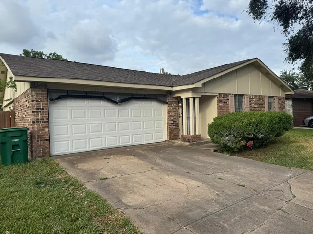 a view of backyard of house and garage