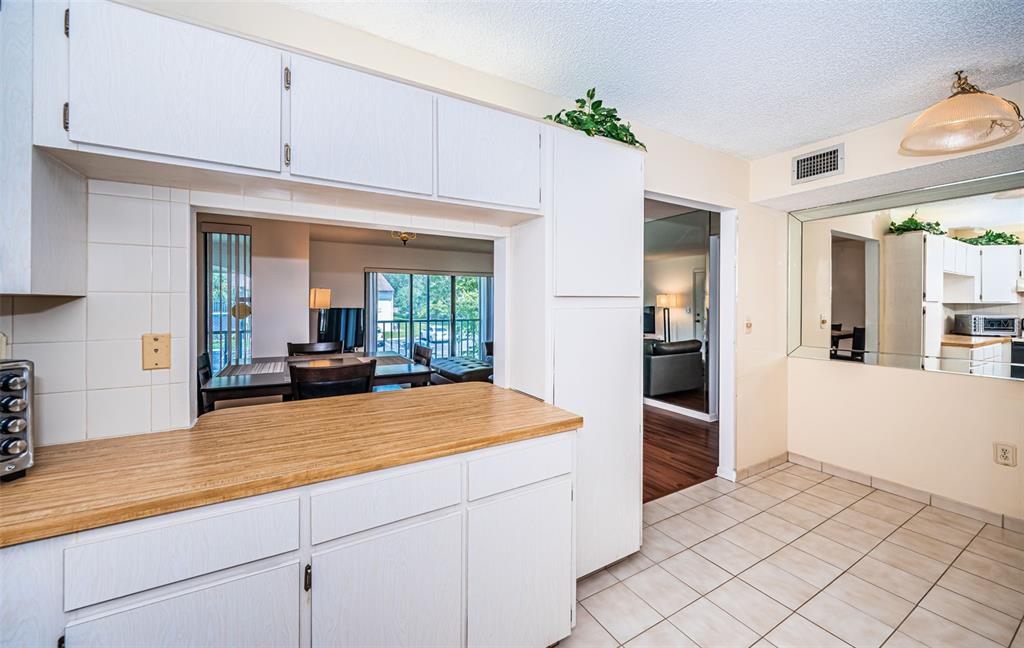 2522 Pine Ridge Way South, Unit A2 Palm Harbor, FL 34684 - Photo 11 of 34 a kitchen with stainless steel appliances a refrigerator and a sink
