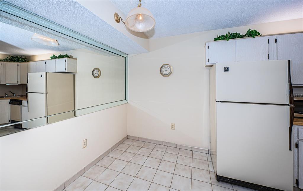 2522 Pine Ridge Way South, Unit A2 Palm Harbor, FL 34684 - Photo 12 of 34 a white refrigerator freezer and a stove sitting inside of a kitchen