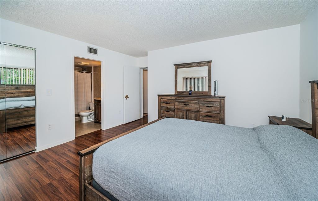 2522 Pine Ridge Way South, Unit A2 Palm Harbor, FL 34684 - Photo 14 of 34 a bedroom with a bed and a dresser