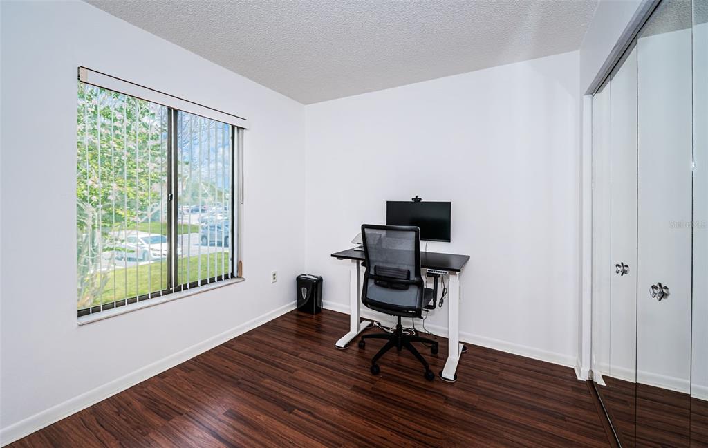2522 Pine Ridge Way South, Unit A2 Palm Harbor, FL 34684 - Photo 16 of 34 a workspace with wooden floor and a window