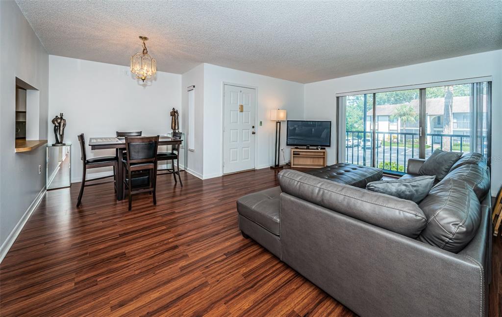2522 Pine Ridge Way South, Unit A2 Palm Harbor, FL 34684 - Photo 5 of 34 a living room with furniture wooden floor and a fireplace