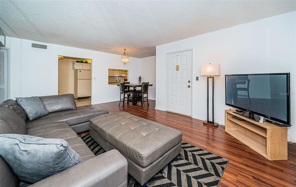 2522 Pine Ridge Way South, Unit A2 Palm Harbor, FL 34684 - Photo 7 of 34 a living room with furniture and wooden floor