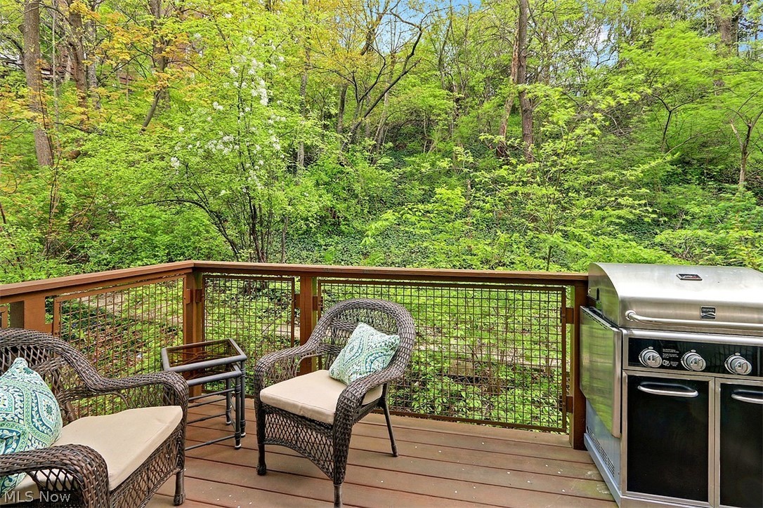 12646 Mayfield Road Cleveland, OH 44106 - Photo 23 of 25 The deck at the back of the townhome faces the woods and looks beautiful in all seasons. The grill will remain with the home.