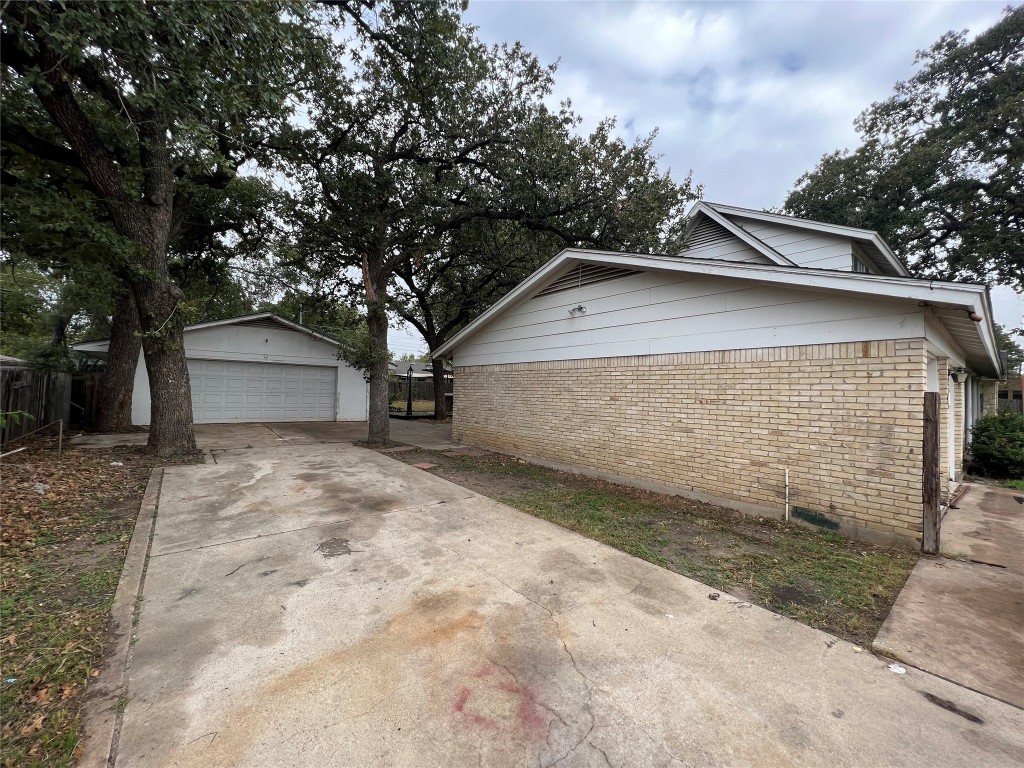 5722 Manor Road Austin, TX 78723 - Photo 2 of 16 a view of a house with a yard and garage