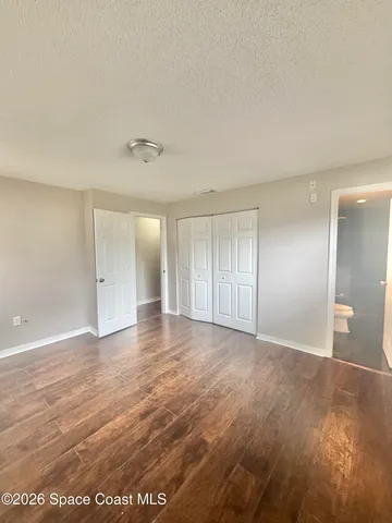 a bathroom with a granite countertop sink a toilet and a mirror