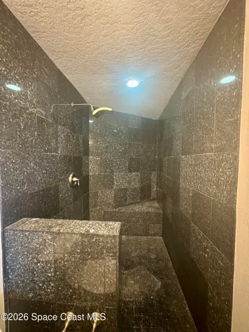 a view of a livingroom with furniture and an empty room