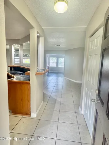a kitchen with granite countertop a refrigerator and a stove top oven