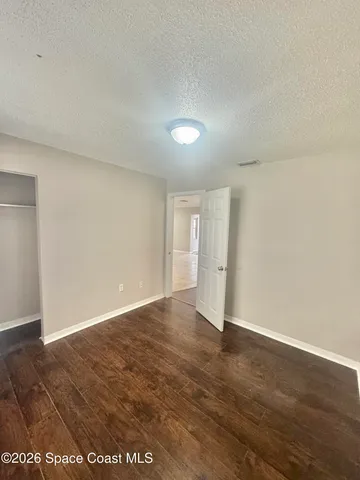 a bathroom with a granite countertop sink toilet a mirror and bathtub