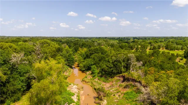 an aerial view of a residential houses with outdoor space