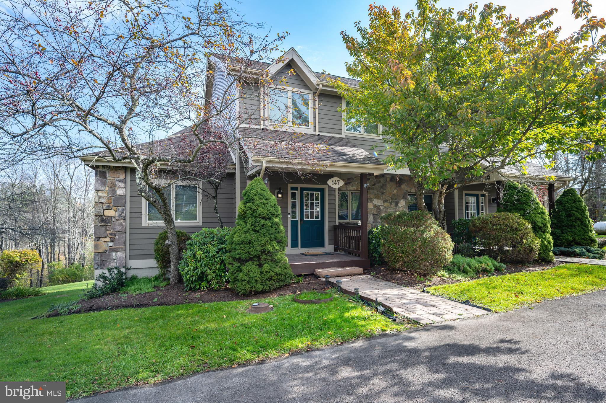 a front view of a house with a yard and porch