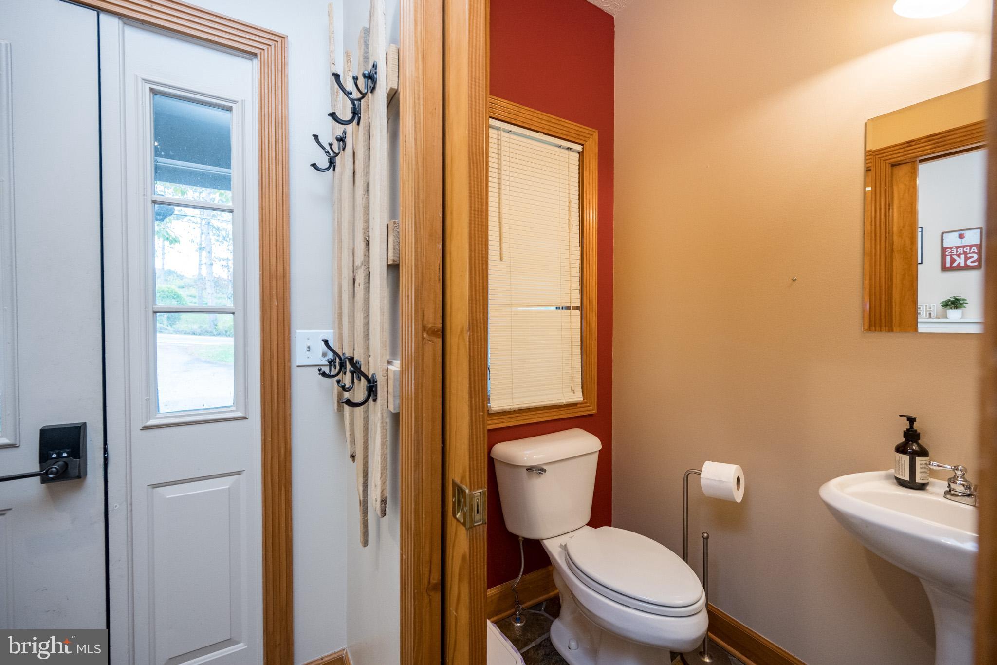 147 Marsh Hill Road McHenry, MD 21541 - Photo 12 of 60 a white toilet sitting next to a bathroom sink