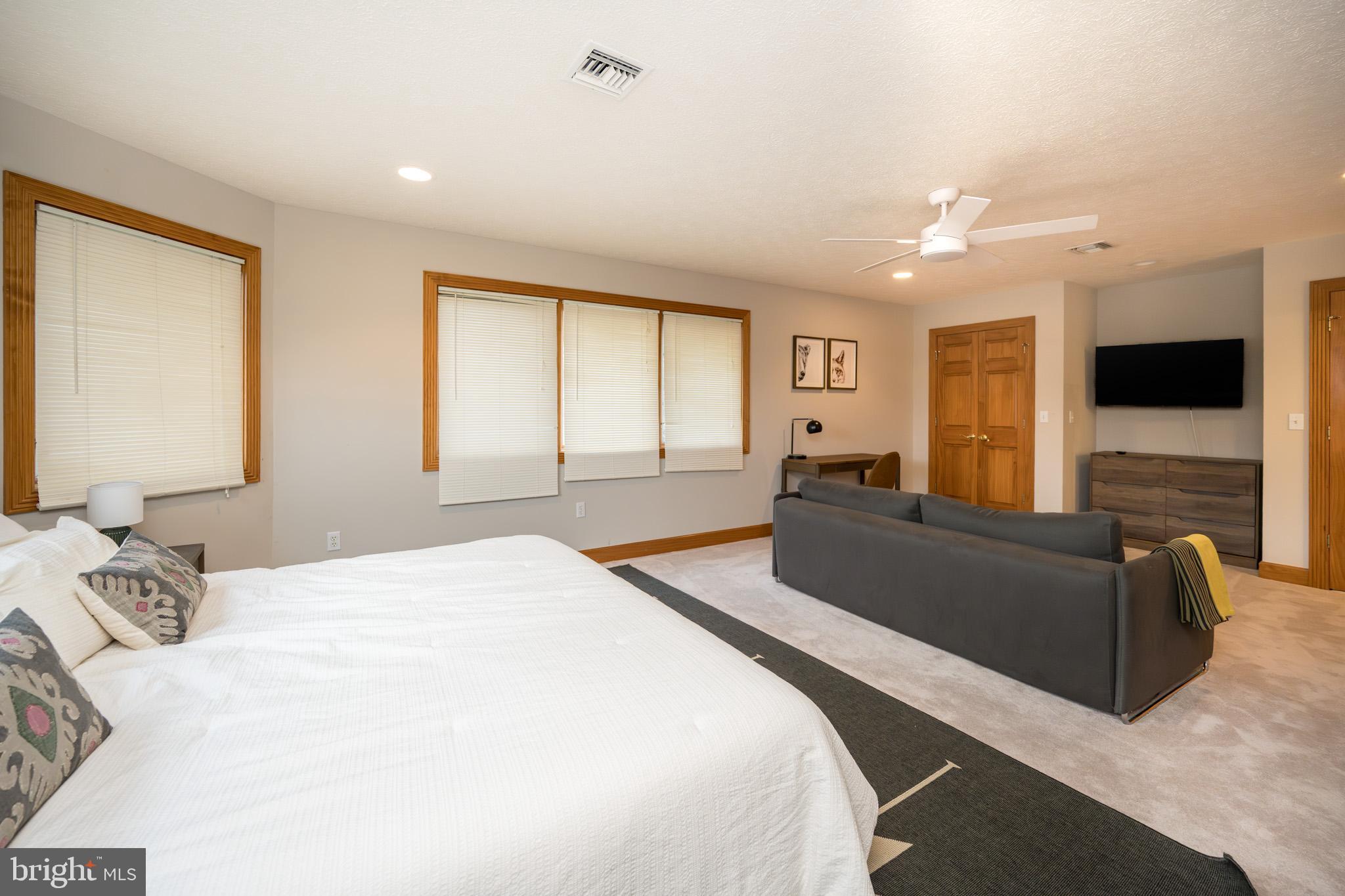 147 Marsh Hill Road McHenry, MD 21541 - Photo 26 of 60 a spacious bedroom with a bed and a couch