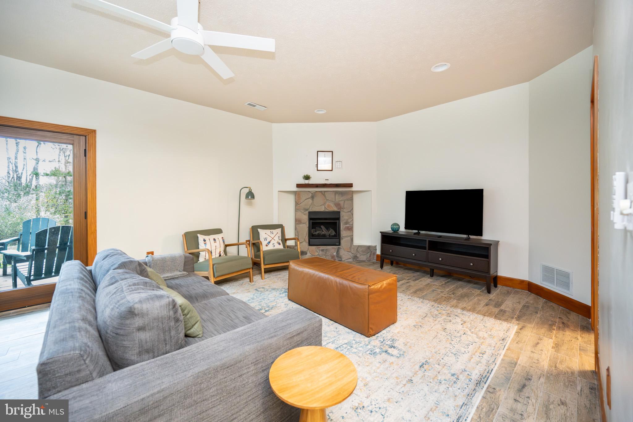 147 Marsh Hill Road McHenry, MD 21541 - Photo 42 of 60 a living room with furniture a flat screen tv and a fireplace