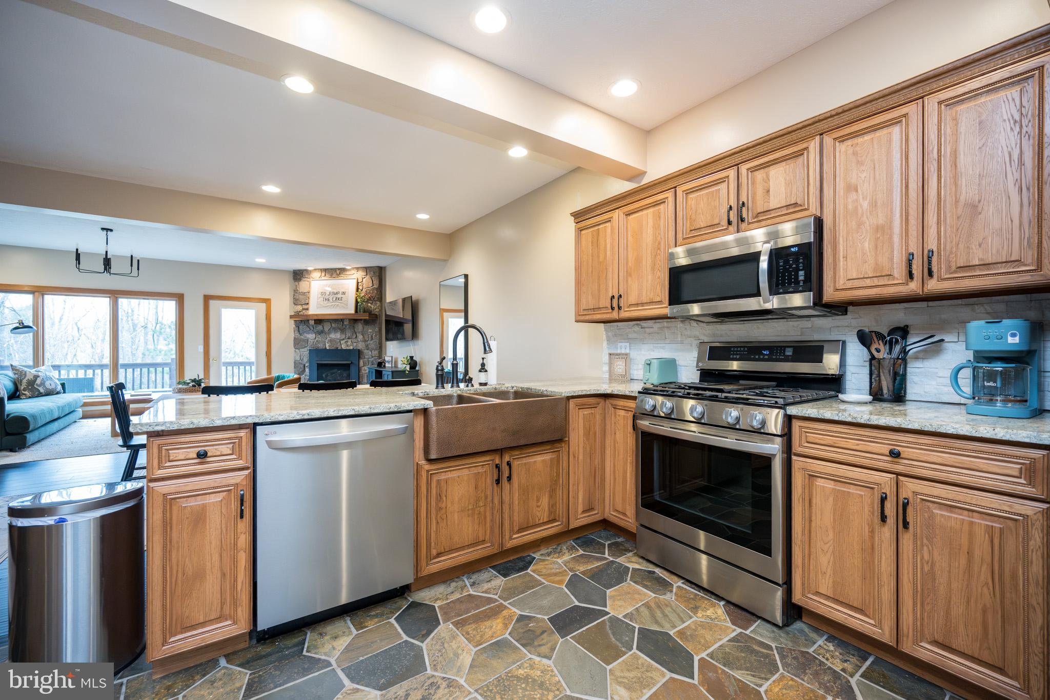 147 Marsh Hill Road McHenry, MD 21541 - Photo 6 of 60 a kitchen with stainless steel appliances granite countertop a sink and cabinets