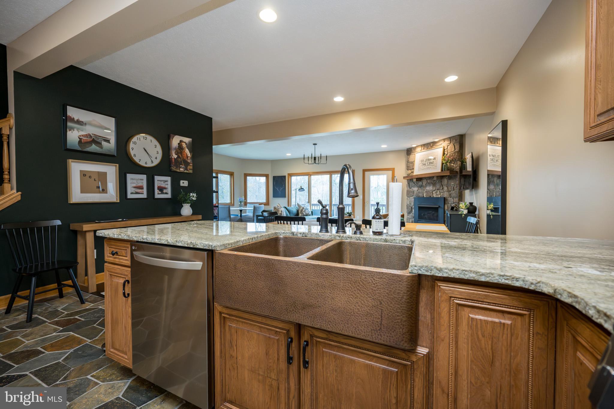 147 Marsh Hill Road McHenry, MD 21541 - Photo 8 of 60 a kitchen with stainless steel appliances granite countertop a sink and a refrigerator