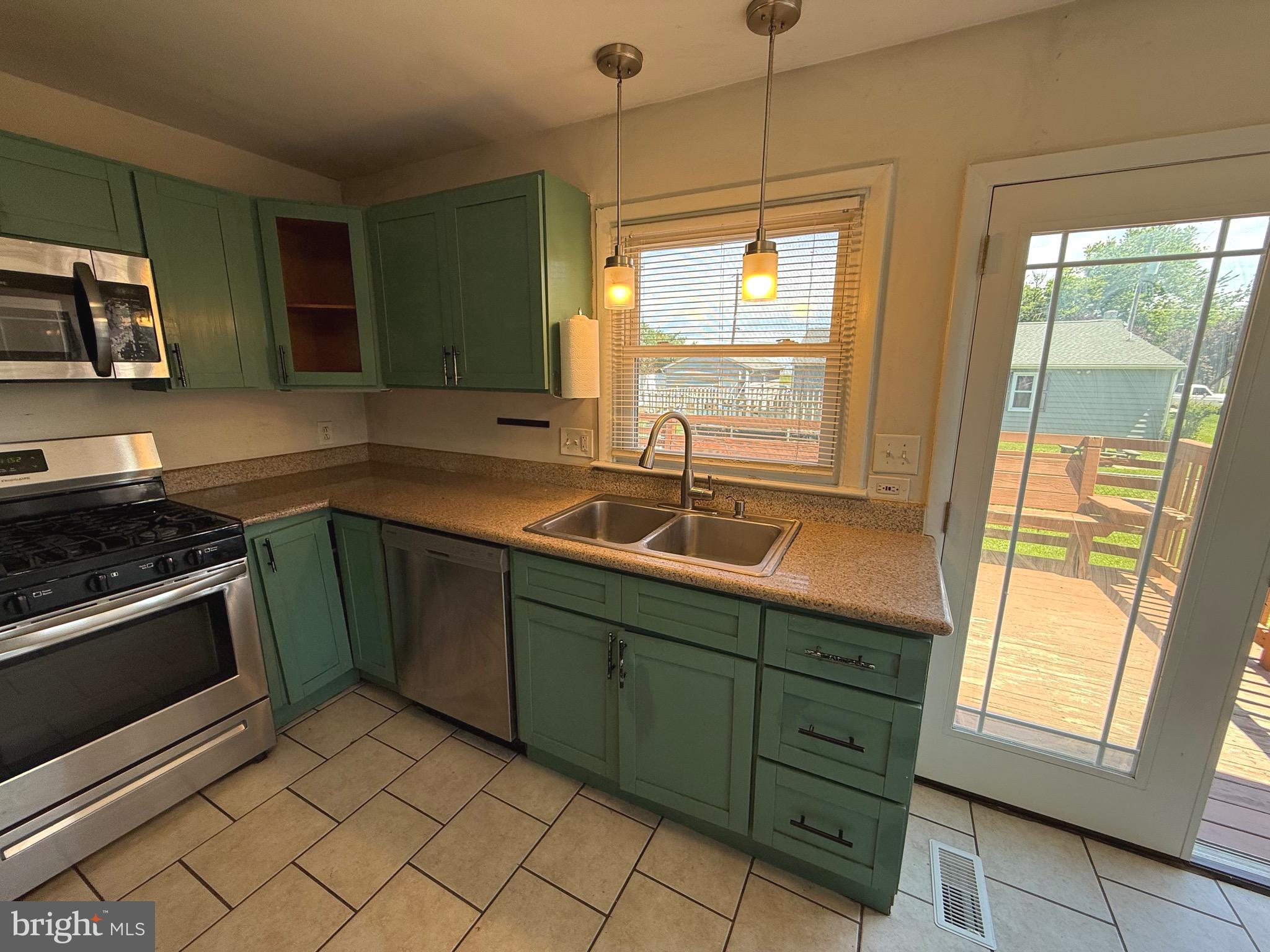 174 Kansas Road Pennsville, NJ 08070 - Photo 11 of 22 a kitchen with a sink stove and microwave