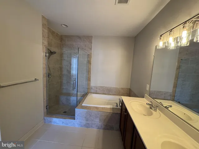 a bathroom with a sink and shower