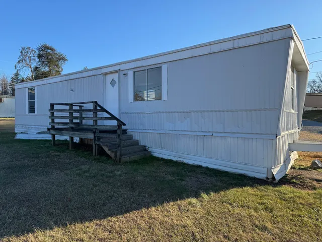 a view of a backyard with wooden fence