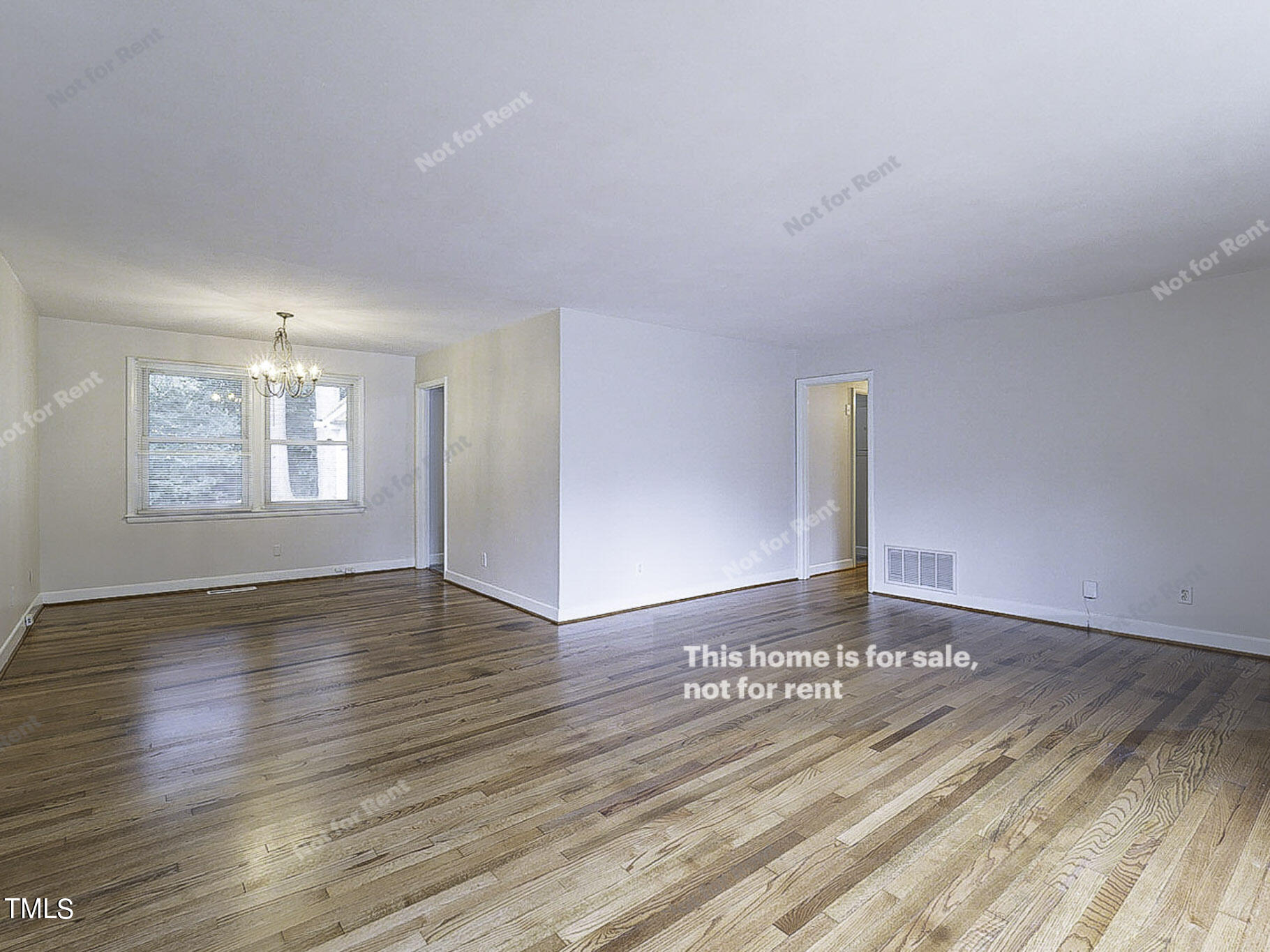 3413 Wade Avenue Raleigh, NC 27607 - Photo 12 of 24 a view of an empty room with wooden floor and a window