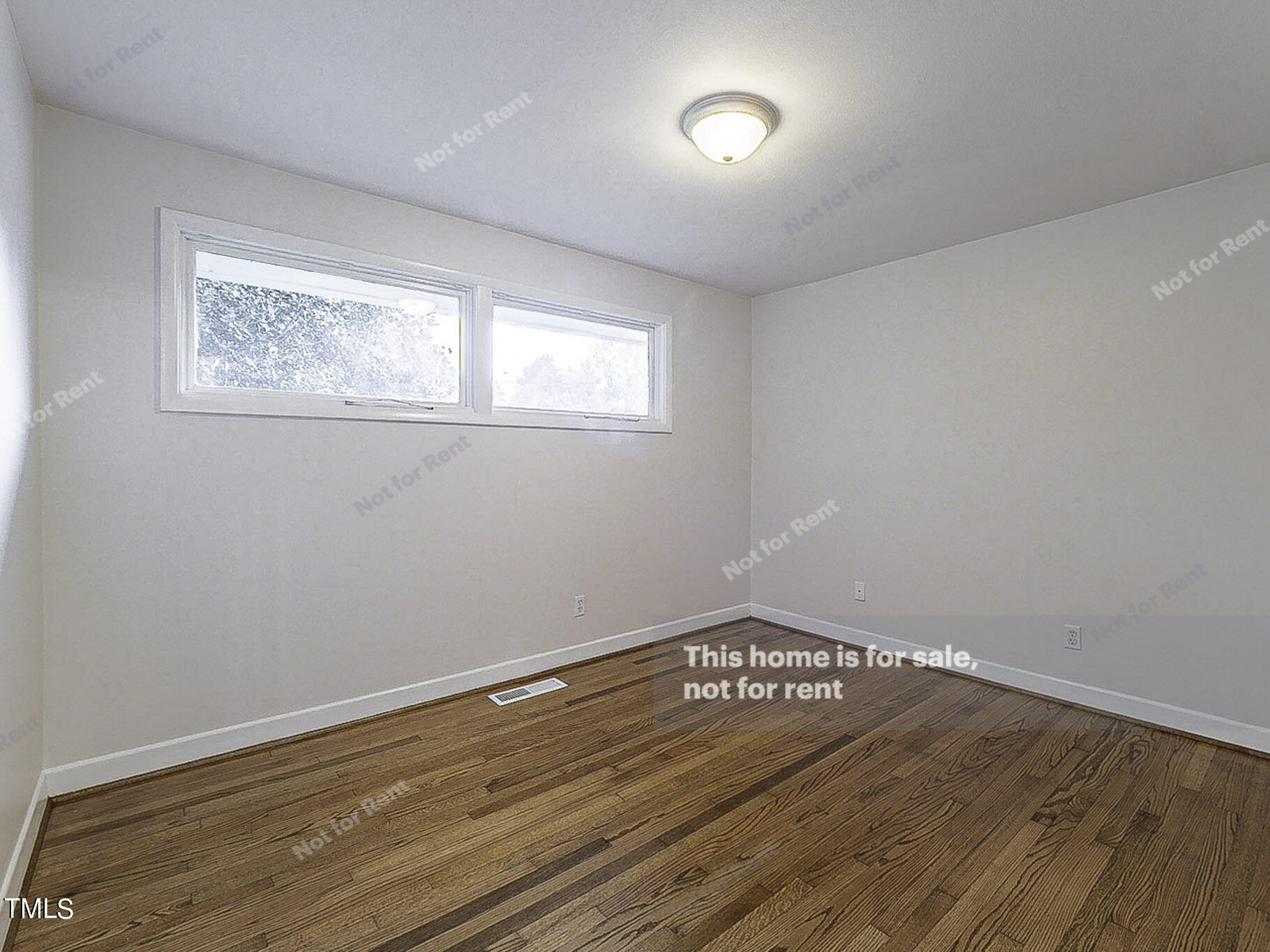 3413 Wade Avenue Raleigh, NC 27607 - Photo 14 of 24 a view of an empty room with wooden floor and a window