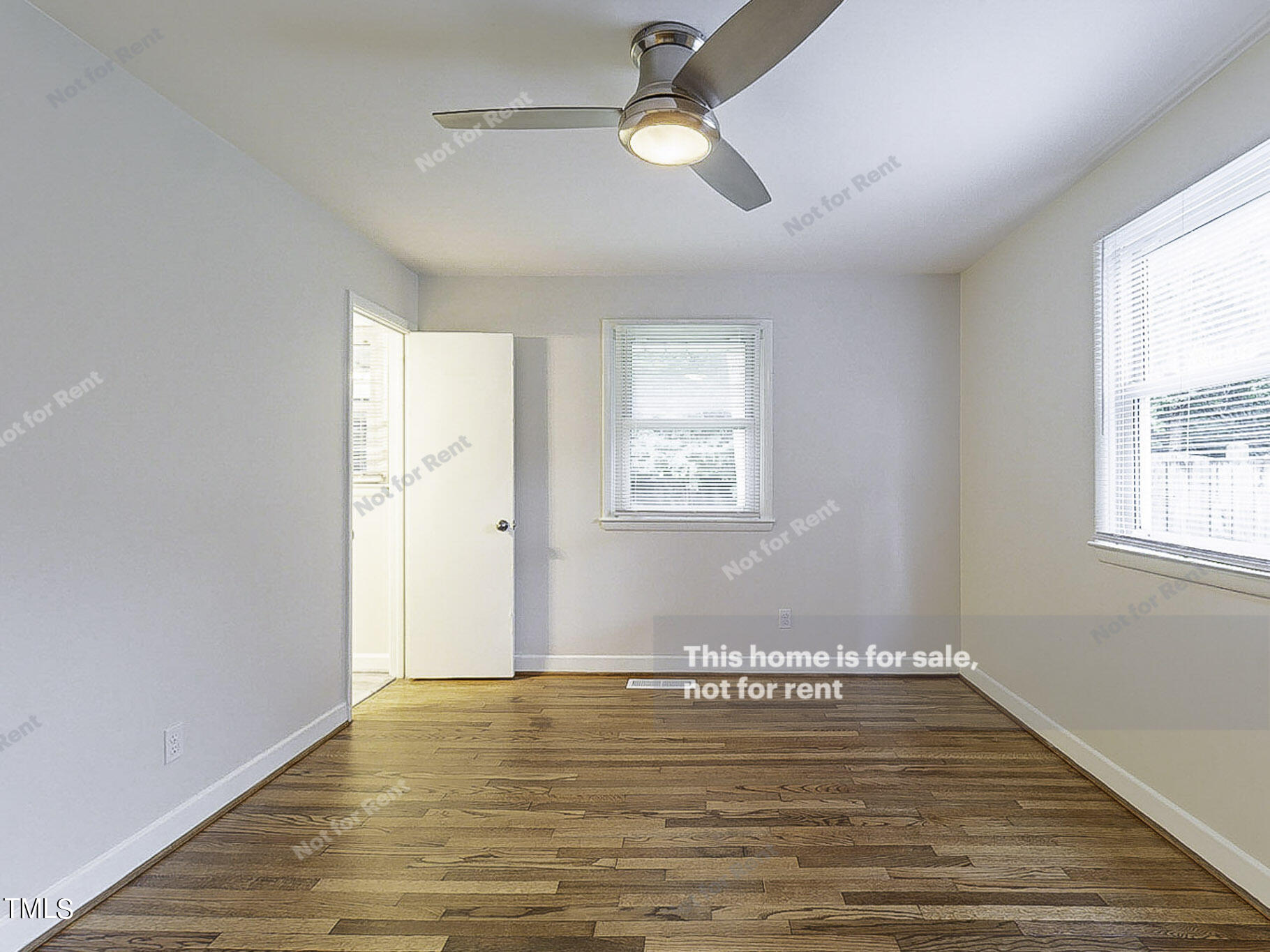 3413 Wade Avenue Raleigh, NC 27607 - Photo 18 of 24 a view of an empty room with wooden floor and a window