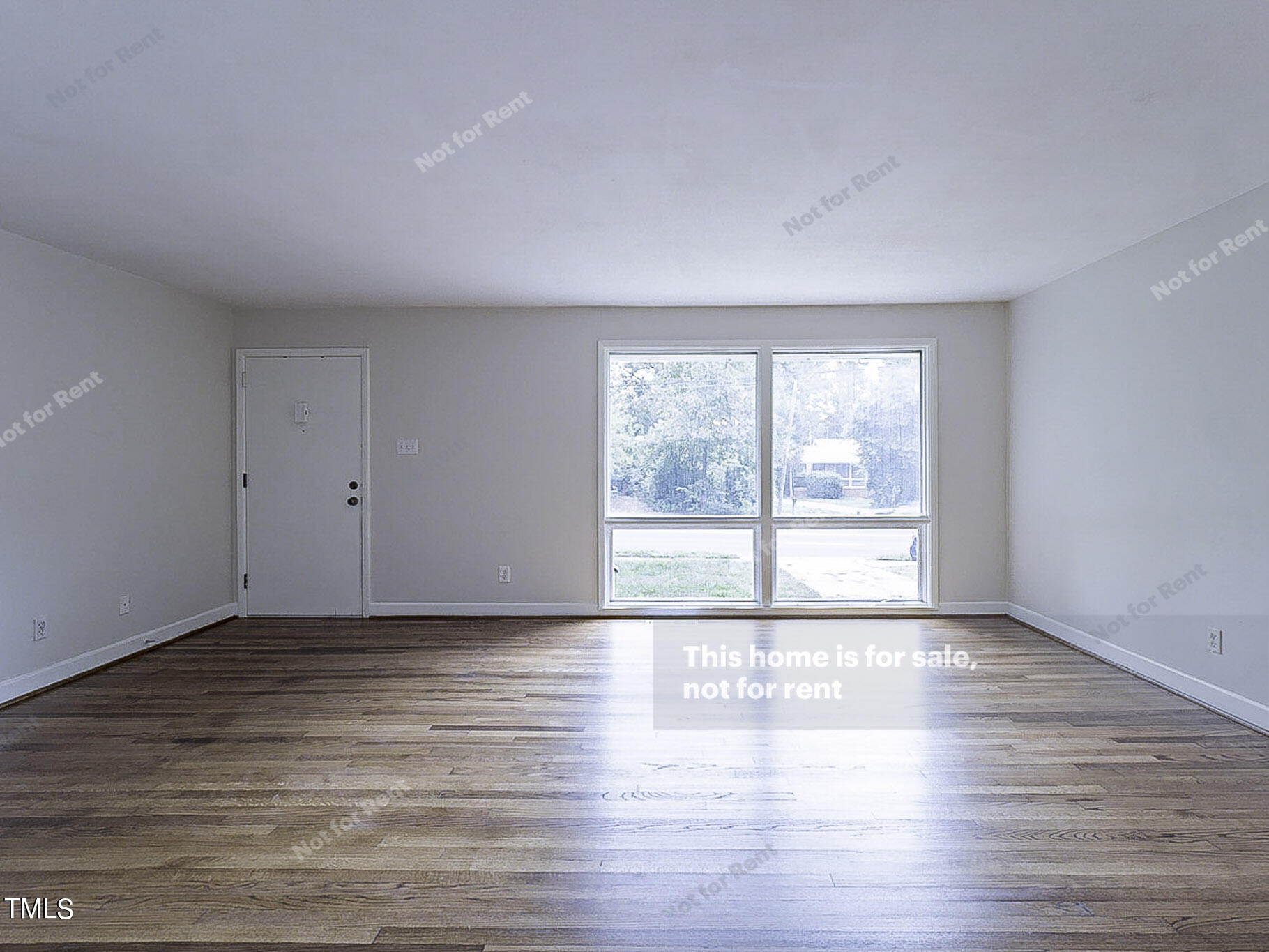 3413 Wade Avenue Raleigh, NC 27607 - Photo 3 of 24 a view of an empty room with wooden floor and a window