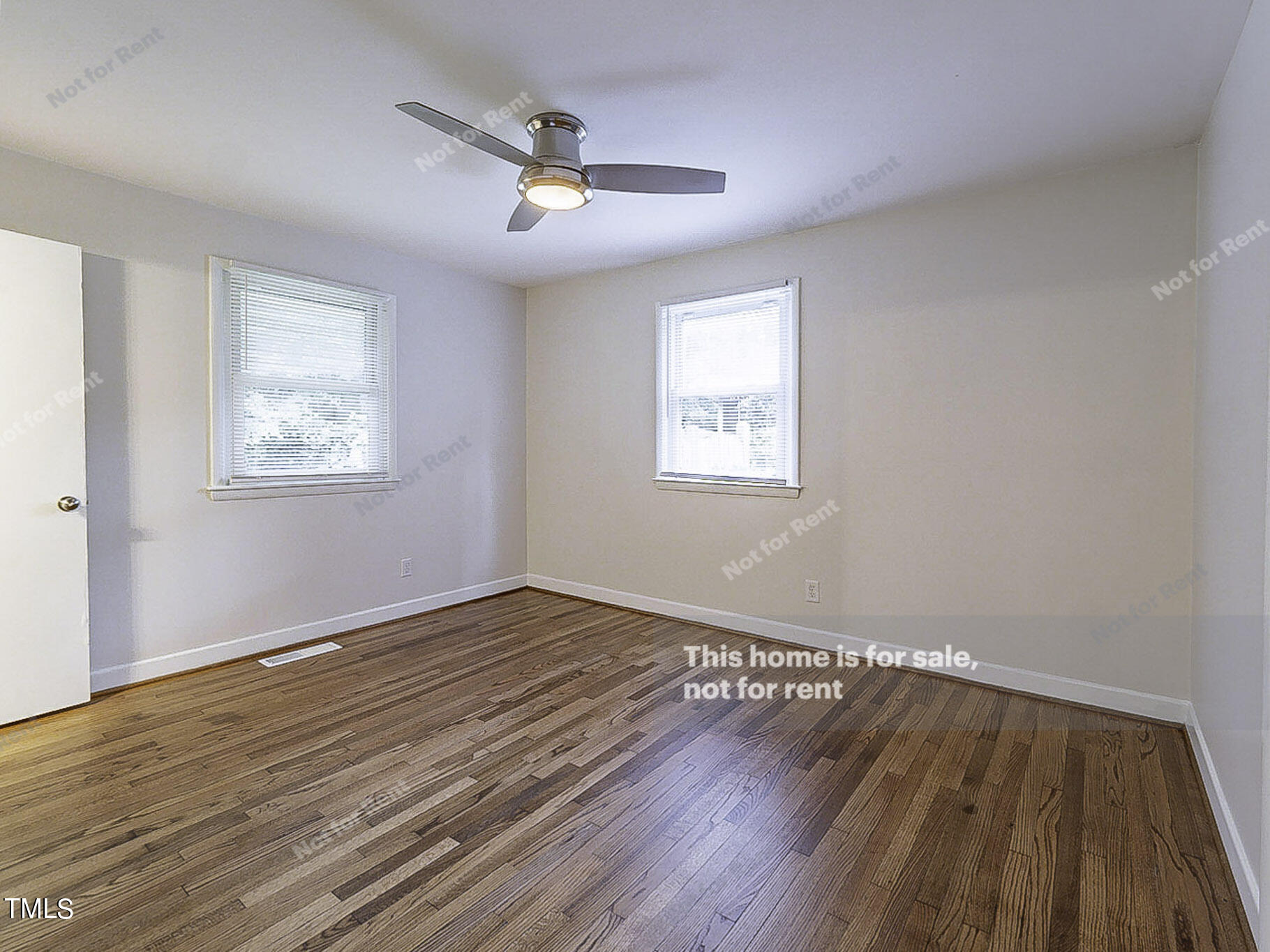 3413 Wade Avenue Raleigh, NC 27607 - Photo 5 of 24 a view of an empty room with wooden floor and a window