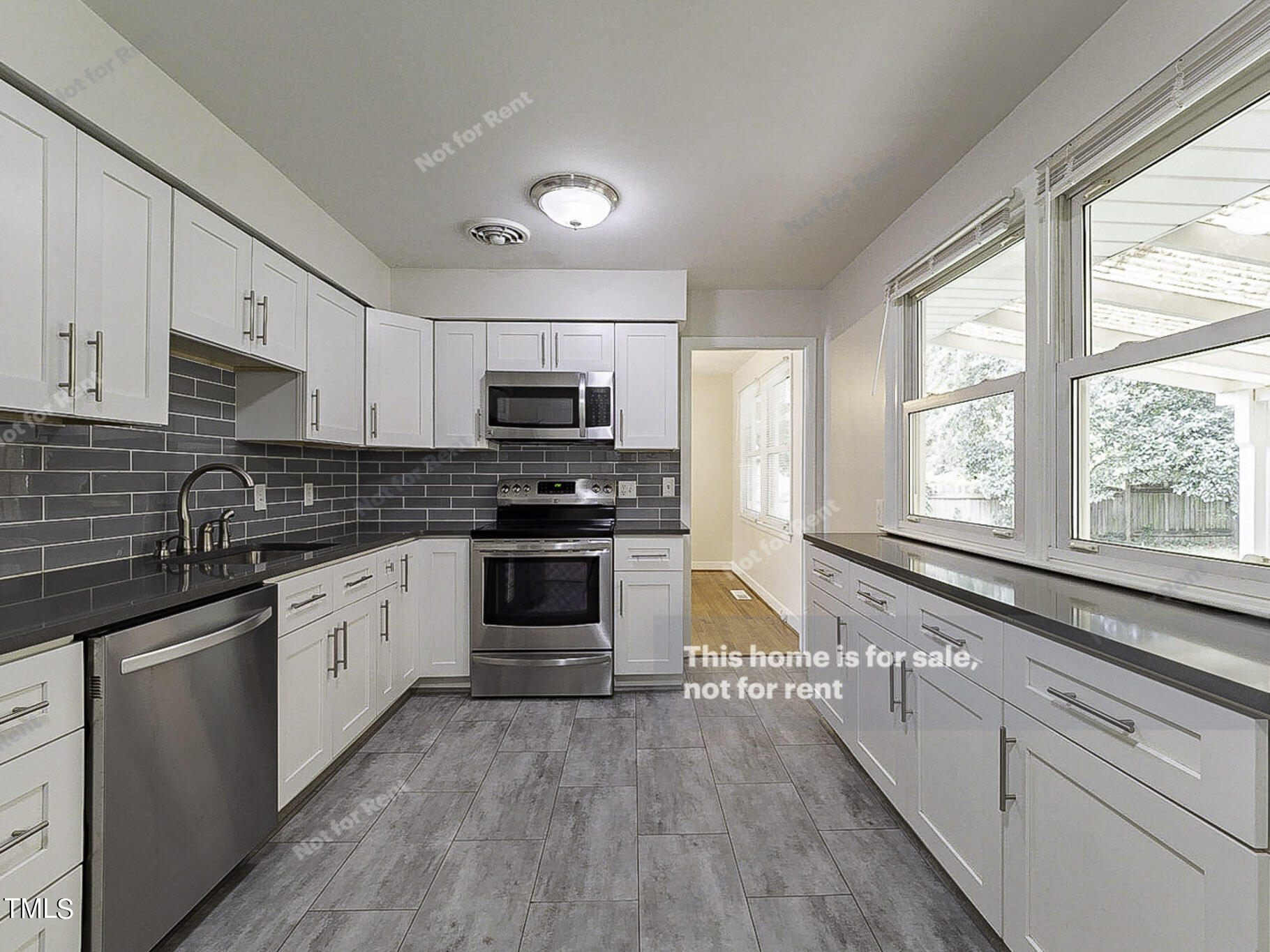 3413 Wade Avenue Raleigh, NC 27607 - Photo 6 of 24 a kitchen with granite countertop white cabinets and appliances